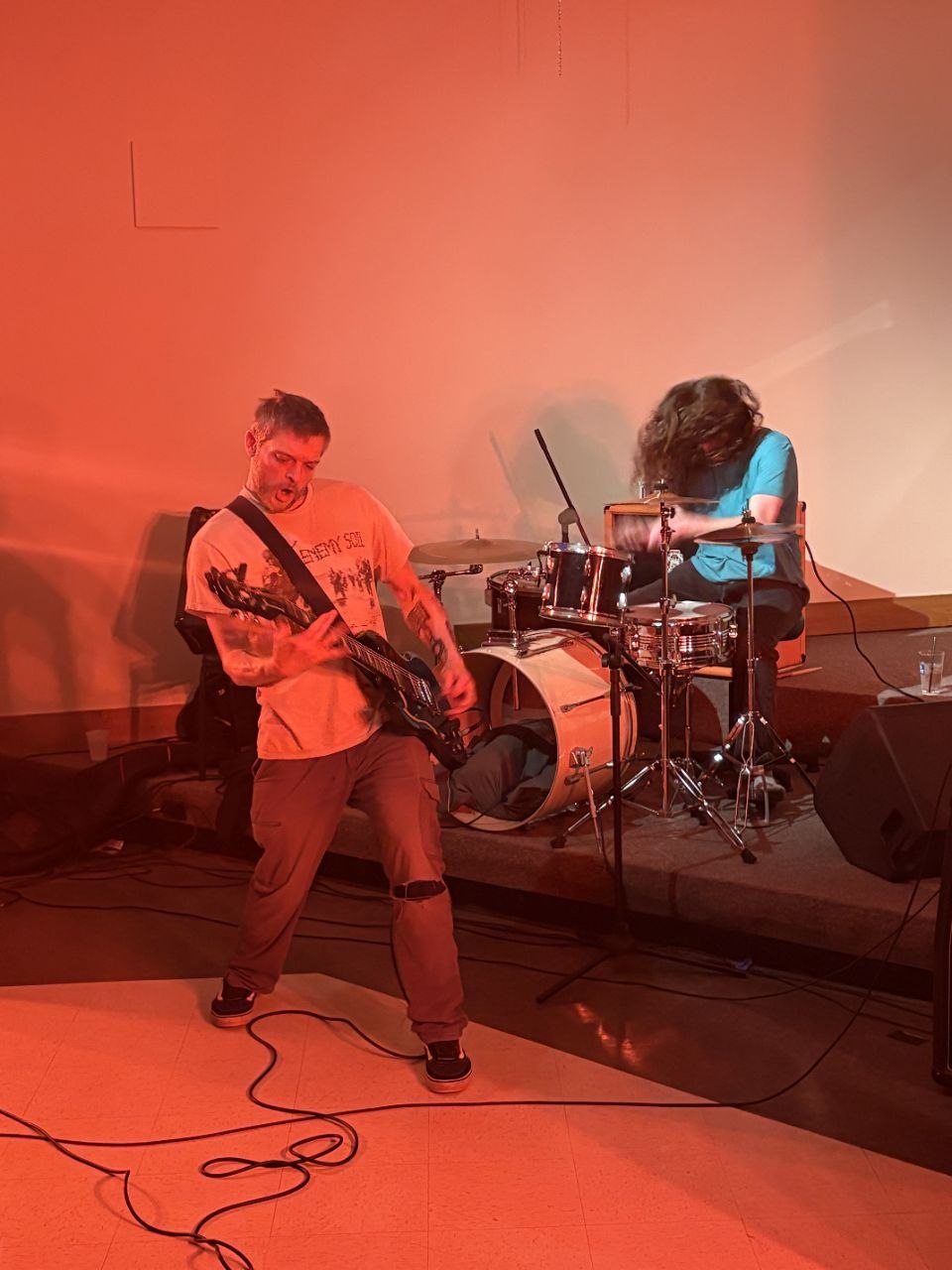 Full stage bathed in orange light, portrait orientation